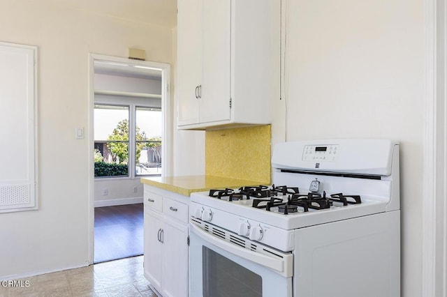 2327 Roscommon Ave, Monterey Park, CA 91754 - kitchen featuring gas range gas stove, white cabinets, baseboards, and light countertops
