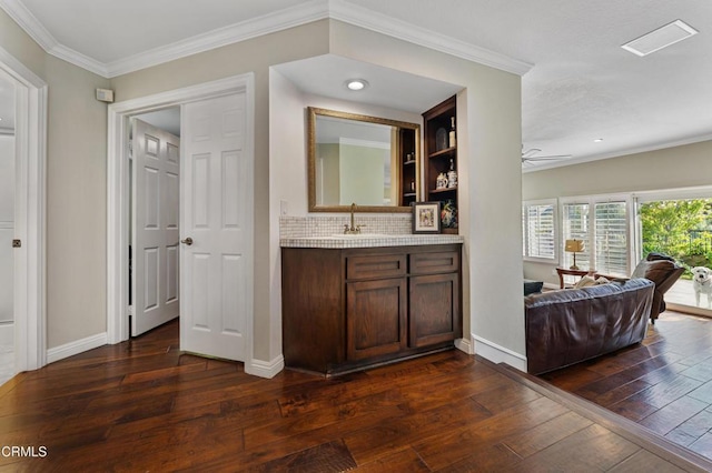 3153 Dragonfly St, Glendale, CA 91206 - bar with dark wood finished floors, crown molding, a sink, backsplash, and baseboards