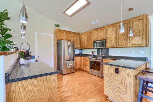 6097 Sherlock Rd, Midpines, CA 95345 - kitchen featuring stainless steel appliances, a sink, a peninsula, dark countertops, and lofted ceiling