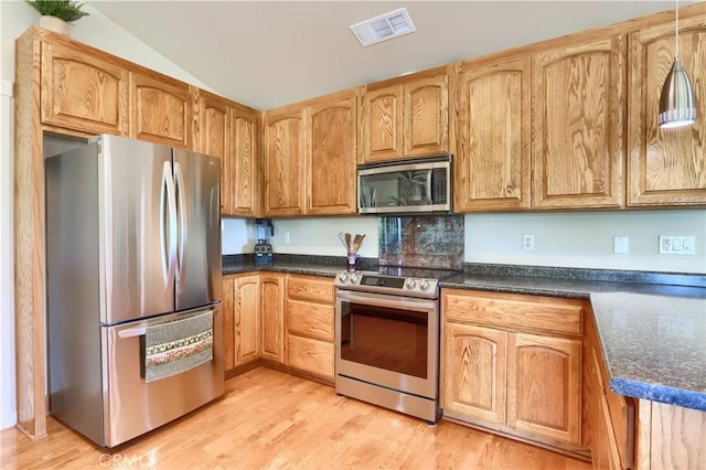 6097 Sherlock Rd, Midpines, CA 95345 - kitchen featuring appliances with stainless steel finishes, dark countertops, light wood finished floors, and lofted ceiling