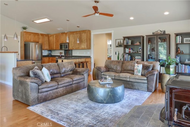 6097 Sherlock Rd, Midpines, CA 95345 - living area with wood finished floors, lofted ceiling, ceiling fan, and recessed lighting