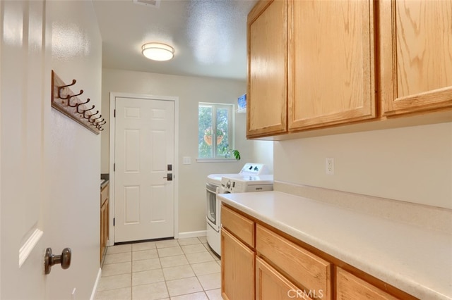 6097 Sherlock Rd, Midpines, CA 95345 - laundry area with independent washer and dryer, light tile patterned floors, cabinet space, and baseboards