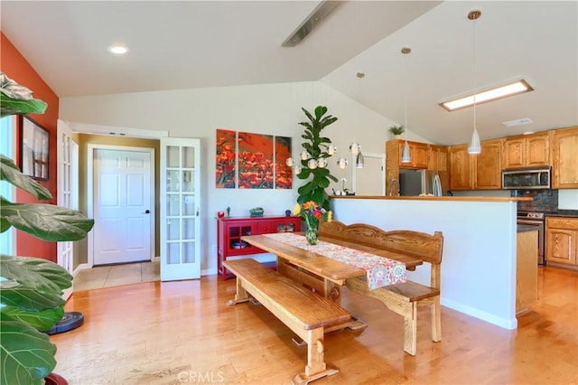 6097 Sherlock Rd, Midpines, CA 95345 - dining area featuring lofted ceiling, light wood finished floors, and french doors
