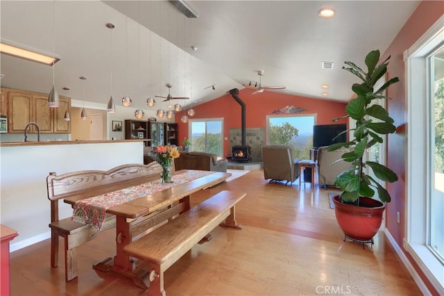 6097 Sherlock Rd, Midpines, CA 95345 - dining space featuring a wood stove, light wood finished floors, a ceiling fan, vaulted ceiling, and recessed lighting