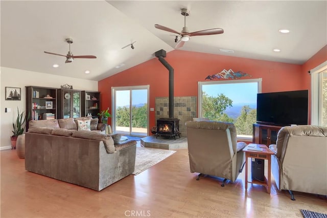 6097 Sherlock Rd, Midpines, CA 95345 - living room featuring a ceiling fan, a wood stove, lofted ceiling, wood finished floors, and recessed lighting