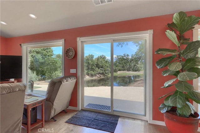 6097 Sherlock Rd, Midpines, CA 95345 - doorway to outside with a water view, light wood-style flooring, baseboards, and recessed lighting