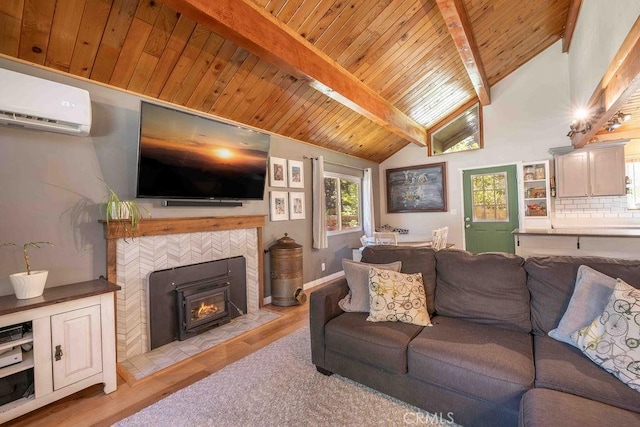 945 Tinker Bell Ave, Big Bear City, CA 92314 - living room featuring a wall unit AC, wooden ceiling, light wood-type flooring, and a tiled fireplace