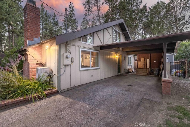 945 Tinker Bell Ave, Big Bear City, CA 92314 - tudor home with a chimney, a carport, and driveway