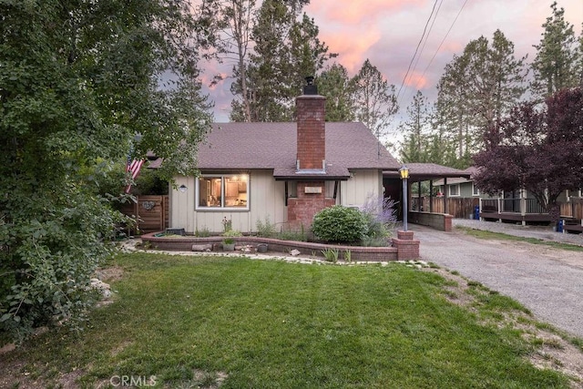 945 Tinker Bell Ave, Big Bear City, CA 92314 - view of front of house featuring a chimney, driveway, a carport, board and batten siding, and roof with shingles