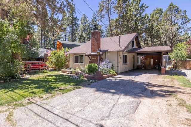 945 Tinker Bell Ave, Big Bear City, CA 92314 - view of front of property with driveway, an attached carport, and a chimney