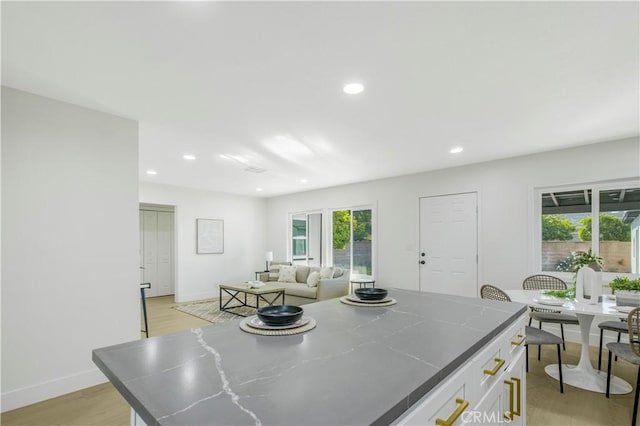 dining area with light wood-style flooring, recessed lighting, and baseboards
