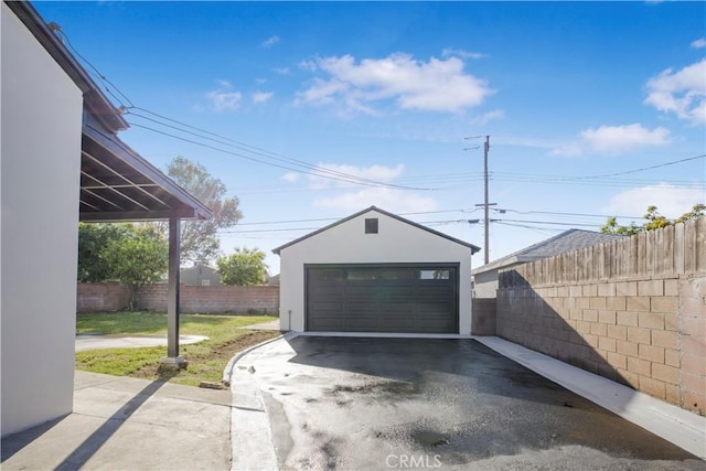 detached garage featuring fence