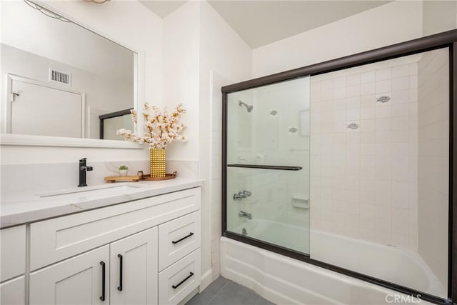 13381 Del Cerro Dr, Tustin, CA 92780 - bathroom featuring tile patterned floors, bath / shower combo with glass door, and vanity