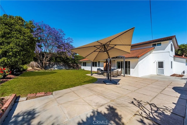 13381 Del Cerro Dr, Tustin, CA 92780 - back of house featuring a tiled roof, stucco siding, and a patio