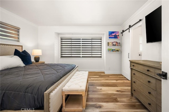 13381 Del Cerro Dr, Tustin, CA 92780 - bedroom featuring a barn door, light wood-style flooring, crown molding, and baseboards