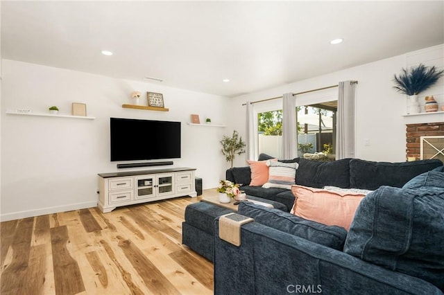 13381 Del Cerro Dr, Tustin, CA 92780 - living room with light wood-style flooring, recessed lighting, baseboards, and a stone fireplace