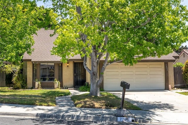 7206 Mimosa Dr, Carlsbad, CA 92011 - obstructed view of property featuring stucco siding, driveway, a garage, and a shingled roof