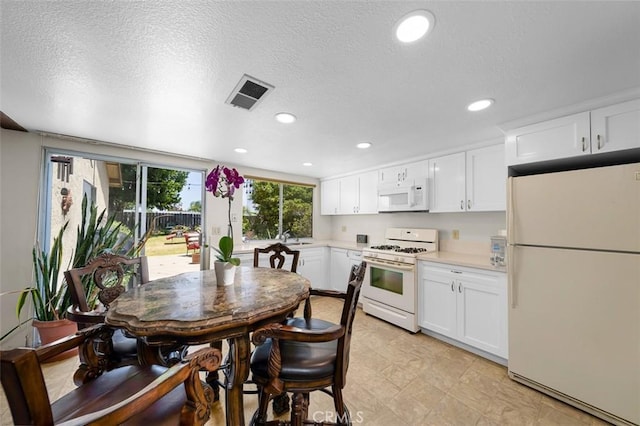7206 Mimosa Dr, Carlsbad, CA 92011 - kitchen featuring white appliances, light countertops, white cabinetry, recessed lighting, and a textured ceiling