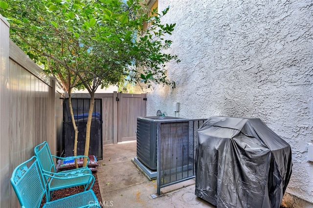 view of patio featuring a grill, fence, and central air condition unit