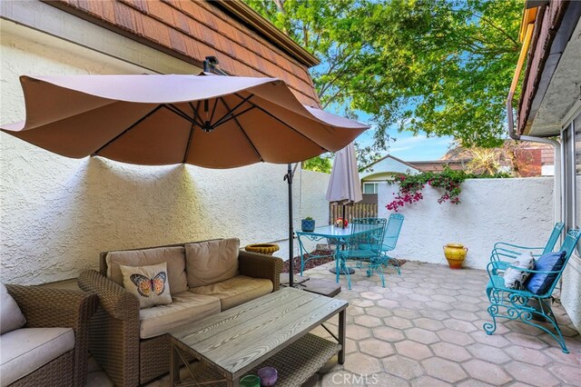 view of patio with outdoor dining space, an outdoor living space, and a fenced backyard