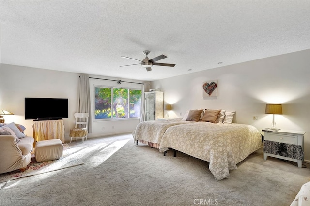 carpeted bedroom featuring a textured ceiling, ceiling fan, and baseboards