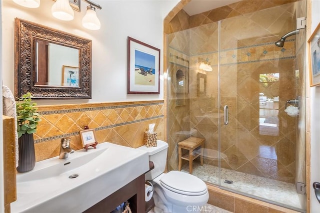 3904 Via Cardelina, Palos Verdes Estates, CA 90274 - bathroom featuring a stall shower, tile walls, toilet, wainscoting, and vanity
