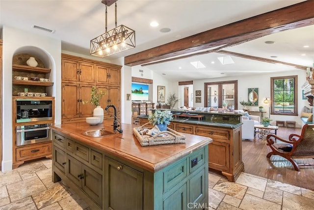 3904 Via Cardelina, Palos Verdes Estates, CA 90274 - kitchen with a sink, oven, open floor plan, a center island with sink, and stone tile flooring