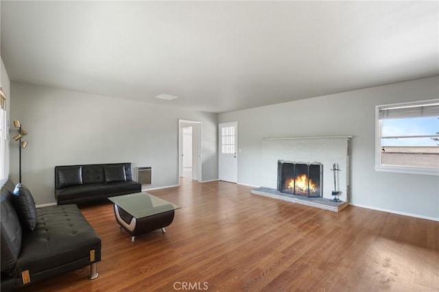 18333 Lancaster Rd, Lancaster, CA 93536 - living room with wood finished floors, a brick fireplace, and baseboards