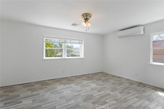 18333 Lancaster Rd, Lancaster, CA 93536 - empty room featuring an AC wall unit, a ceiling fan, wood finished floors, and baseboards