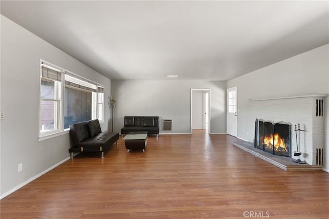 18333 Lancaster Rd, Lancaster, CA 93536 - living room with wood finished floors, a fireplace, and baseboards