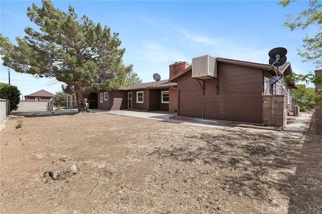 18333 Lancaster Rd, Lancaster, CA 93536 - back of house with a chimney and a patio