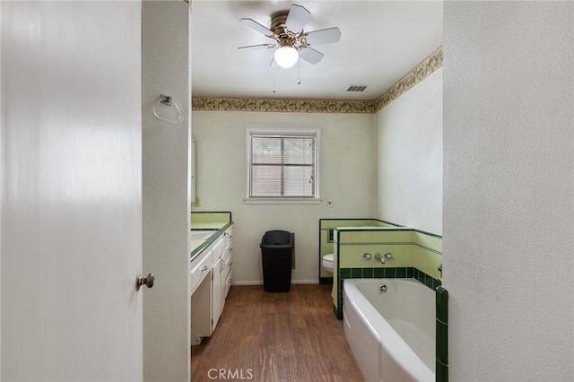 18333 Lancaster Rd, Lancaster, CA 93536 - full bath featuring a bath, a ceiling fan, vanity, wood finished floors, and toilet