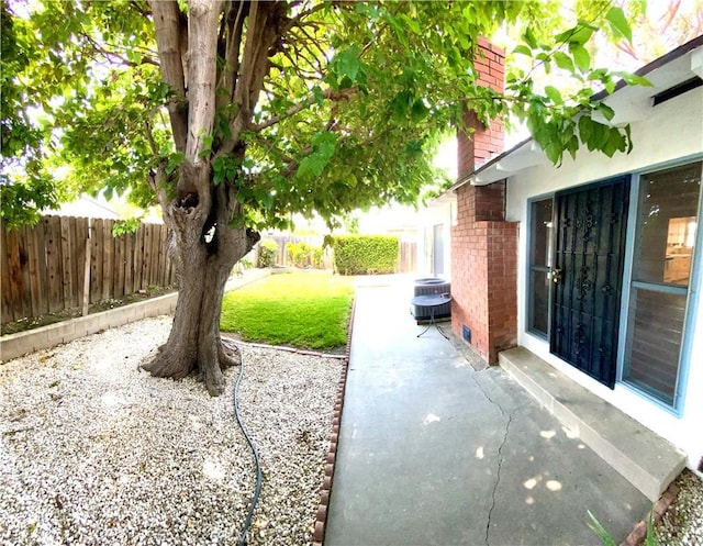 view of yard featuring a patio and central air condition unit