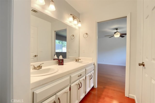 43038 Glacier Ln, Coarsegold, CA 93614 - bathroom with wood finished floors, a ceiling fan, and double vanity