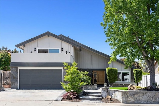 25232 Grissom Rd, Laguna Hills, CA 92653 - view of front of house with board and batten siding, driveway, an attached garage, fence, and a balcony