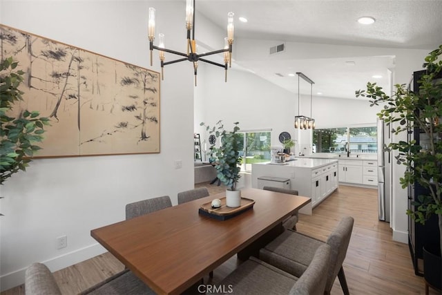 25232 Grissom Rd, Laguna Hills, CA 92653 - dining space with a chandelier, recessed lighting, light wood-style floors, and high vaulted ceiling
