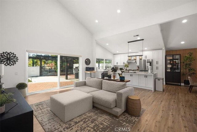 25232 Grissom Rd, Laguna Hills, CA 92653 - living room featuring high vaulted ceiling, light wood-style flooring, and recessed lighting