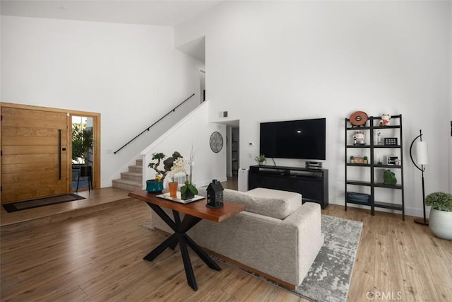 25232 Grissom Rd, Laguna Hills, CA 92653 - living room with a high ceiling, stairway, and wood finished floors