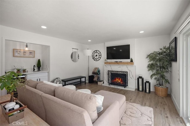 25232 Grissom Rd, Laguna Hills, CA 92653 - living room featuring a premium fireplace, light wood-style flooring, and recessed lighting