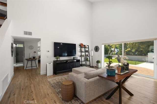 25232 Grissom Rd, Laguna Hills, CA 92653 - living room with a high ceiling, healthy amount of natural light, wood finished floors, and baseboards