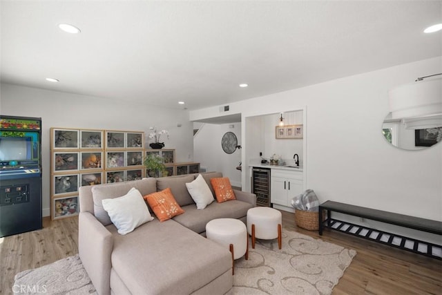 25232 Grissom Rd, Laguna Hills, CA 92653 - living room featuring bar with sink, beverage cooler, light wood-style flooring, and recessed lighting