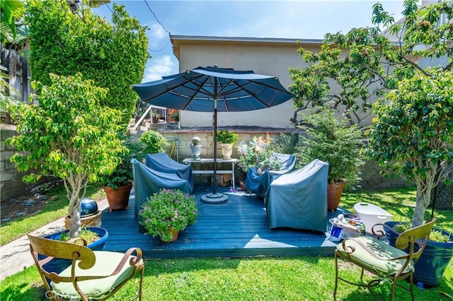 wooden terrace with a lawn