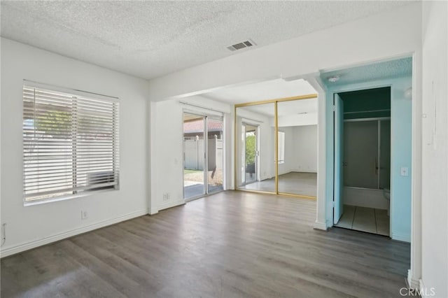 82075 Country Club Dr Unit 31, Indio, CA 92201 - unfurnished bedroom with wood finished floors, a textured ceiling, and baseboards
