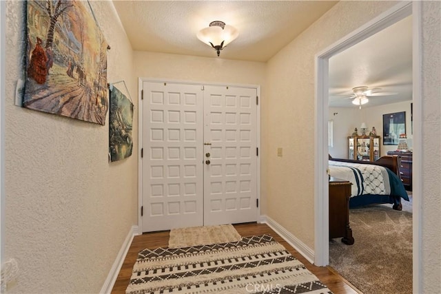 7795 Richard Dr, Lucerne, CA 95458 - entrance foyer featuring a textured wall, wood finished floors, a ceiling fan, and baseboards