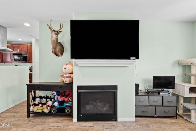 126 E Ventura St Unit F, Santa Paula, CA 93060 - living area featuring light wood-style floors, recessed lighting, and a fireplace