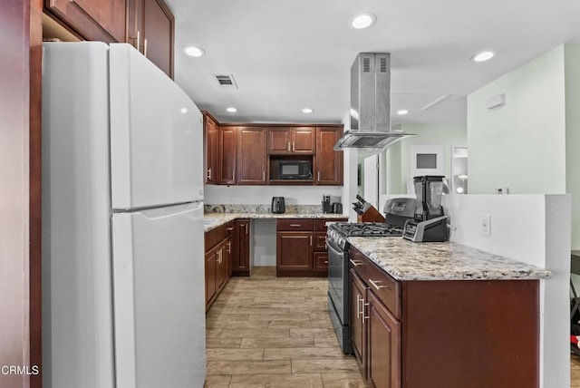 126 E Ventura St Unit F, Santa Paula, CA 93060 - kitchen with freestanding refrigerator, gas range, island exhaust hood, black microwave, and light wood finished floors