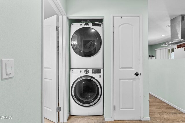 126 E Ventura St Unit F, Santa Paula, CA 93060 - washroom with stacked washer / dryer and wood finished floors