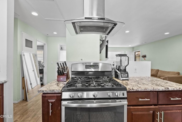 126 E Ventura St Unit F, Santa Paula, CA 93060 - kitchen featuring stainless steel range with gas cooktop, island range hood, light wood finished floors, light stone counters, and recessed lighting