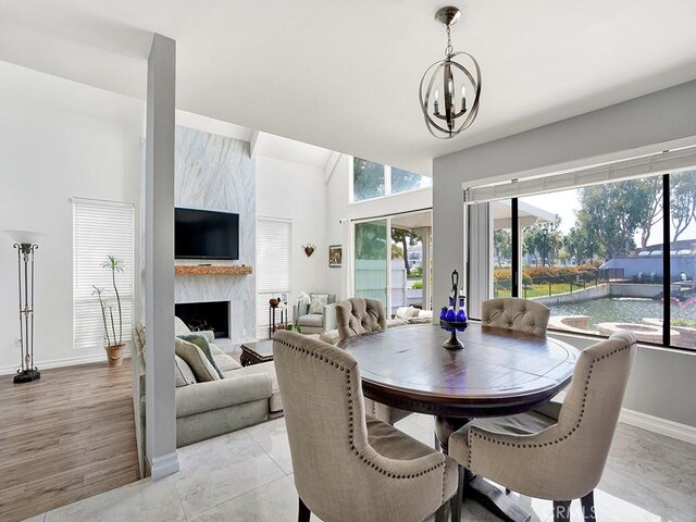 3842 Montego Dr, Huntington Beach, CA 92649 - dining room featuring a chandelier, a high end fireplace, and baseboards