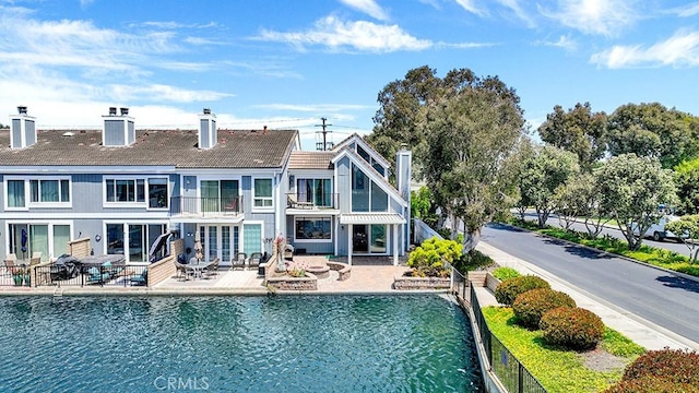 3842 Montego Dr, Huntington Beach, CA 92649 - rear view of house featuring a balcony, a chimney, a patio, and fence